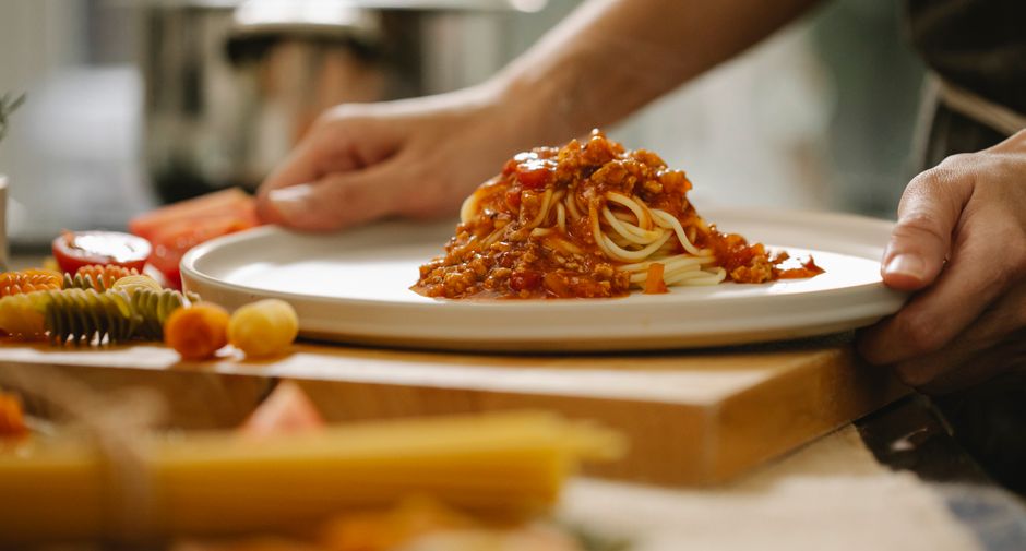 Italian chef preparing fresh handmade pasta in professional kitchen