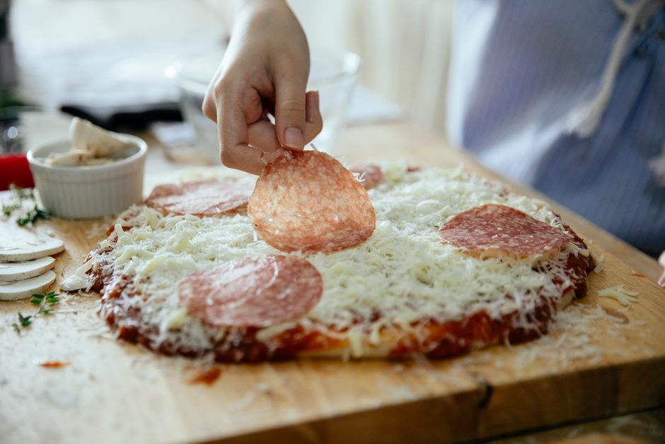 Premium wood-fired pizza preparation in an open kitchen